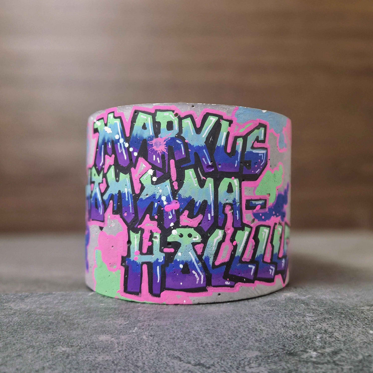 Unplanted custom graffiti pot covered in colourful names and lettering