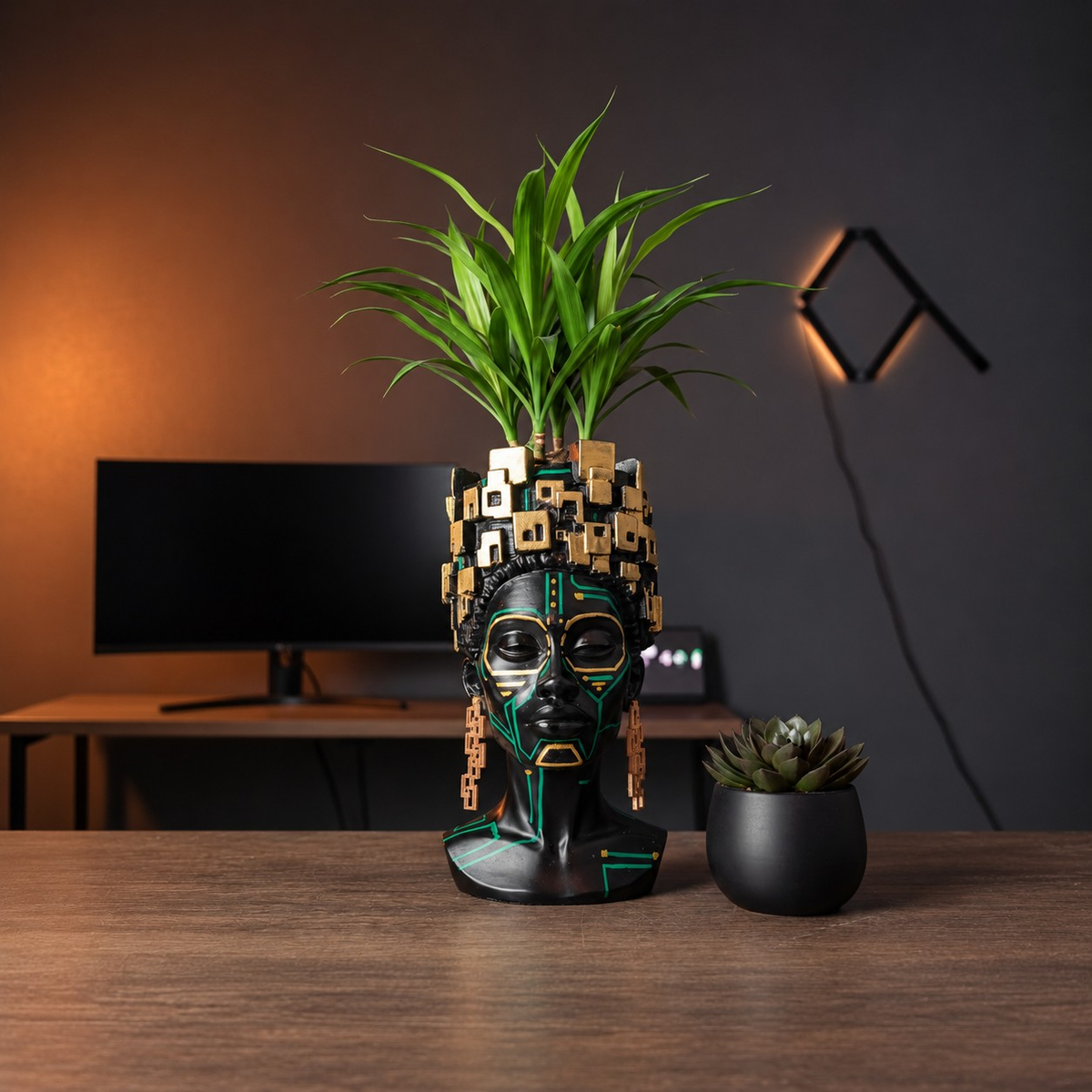 The Motherboard head planter with a dracaena on a home-office desk