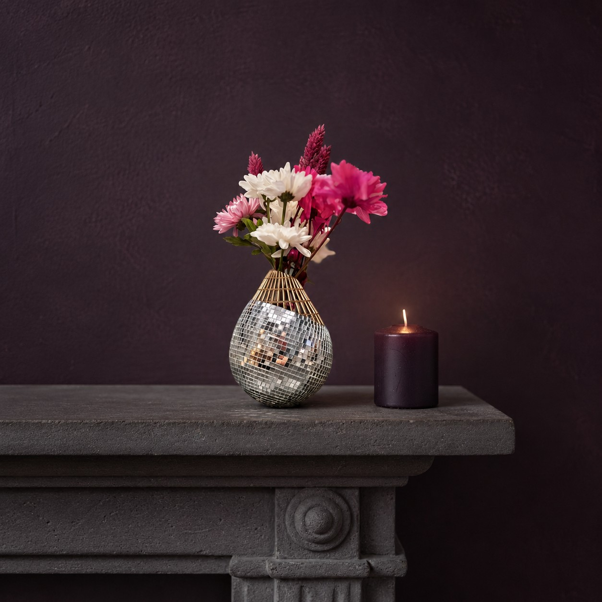 Mirror mosaic vase on mantelpiece with dried flowers