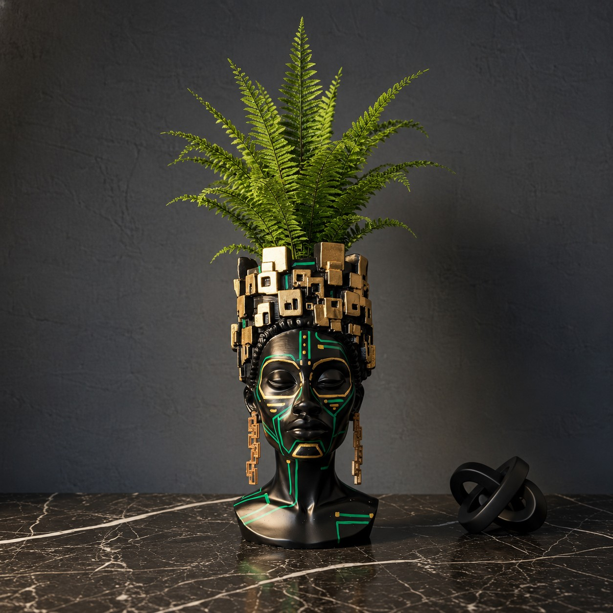 The Motherboard head planter with a fern on a dark marble surface