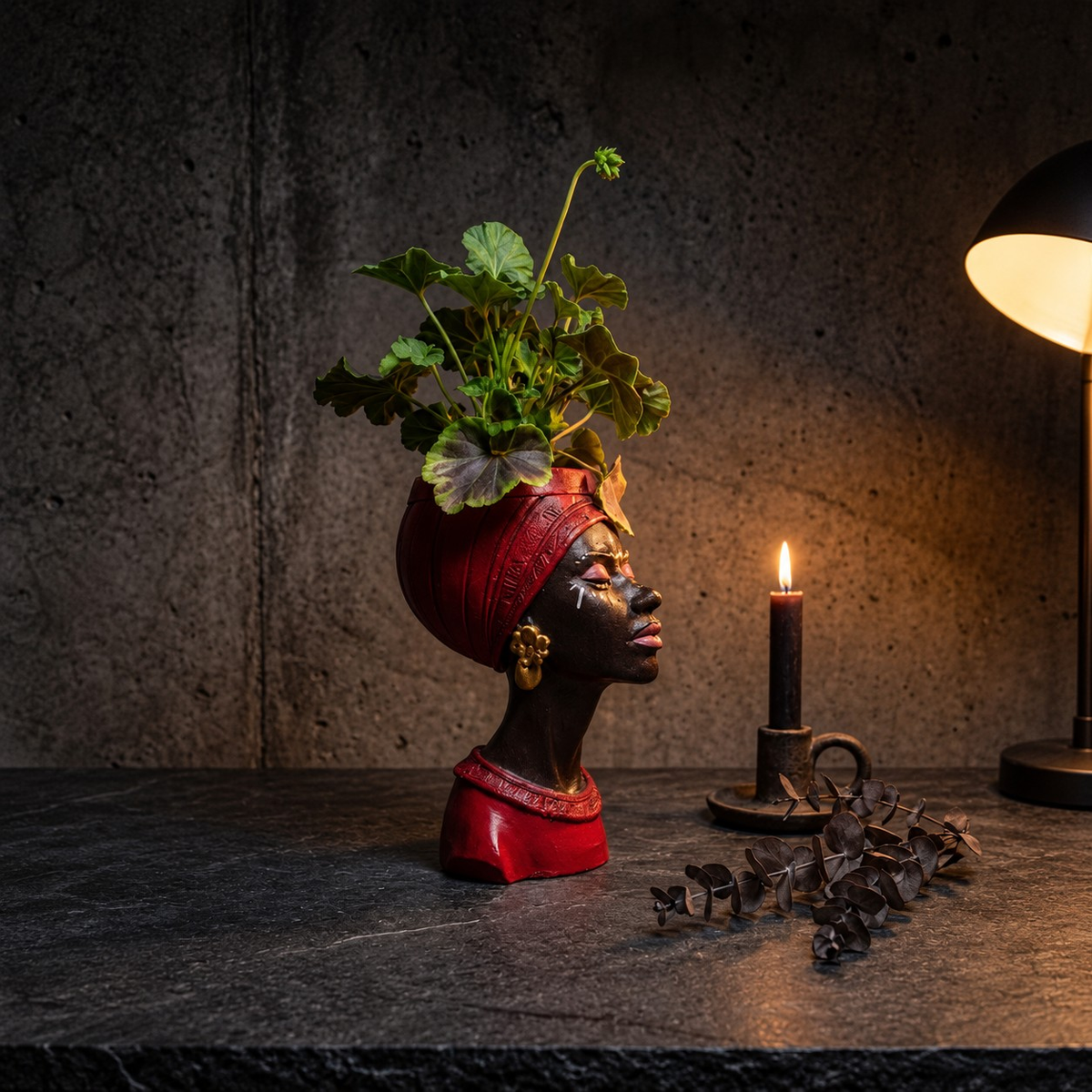 Red Afro woman head planter styled on a shelf beside a candle
