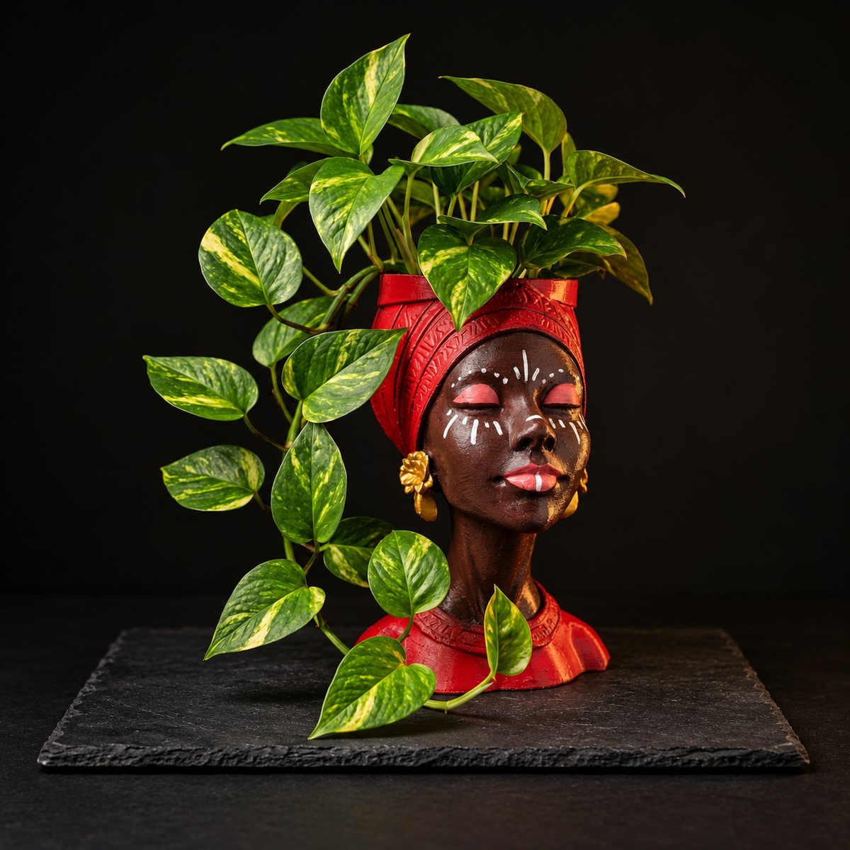 Red Afro woman head planter filled with trailing pothos leaves