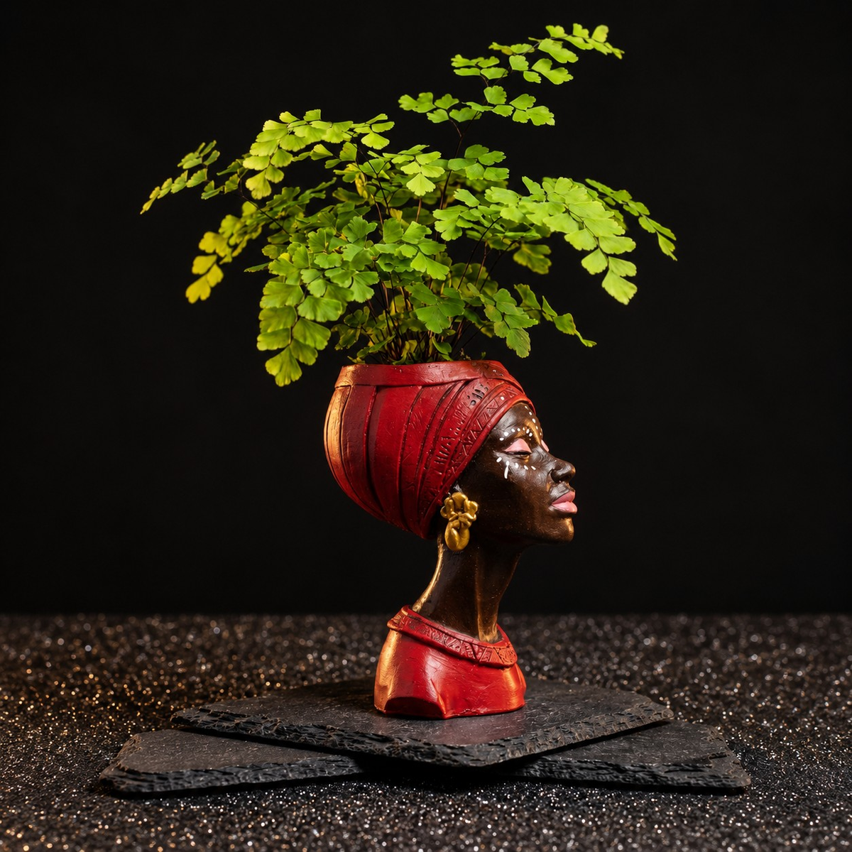 Red Afro woman head planter in right profile with maidenhair fern