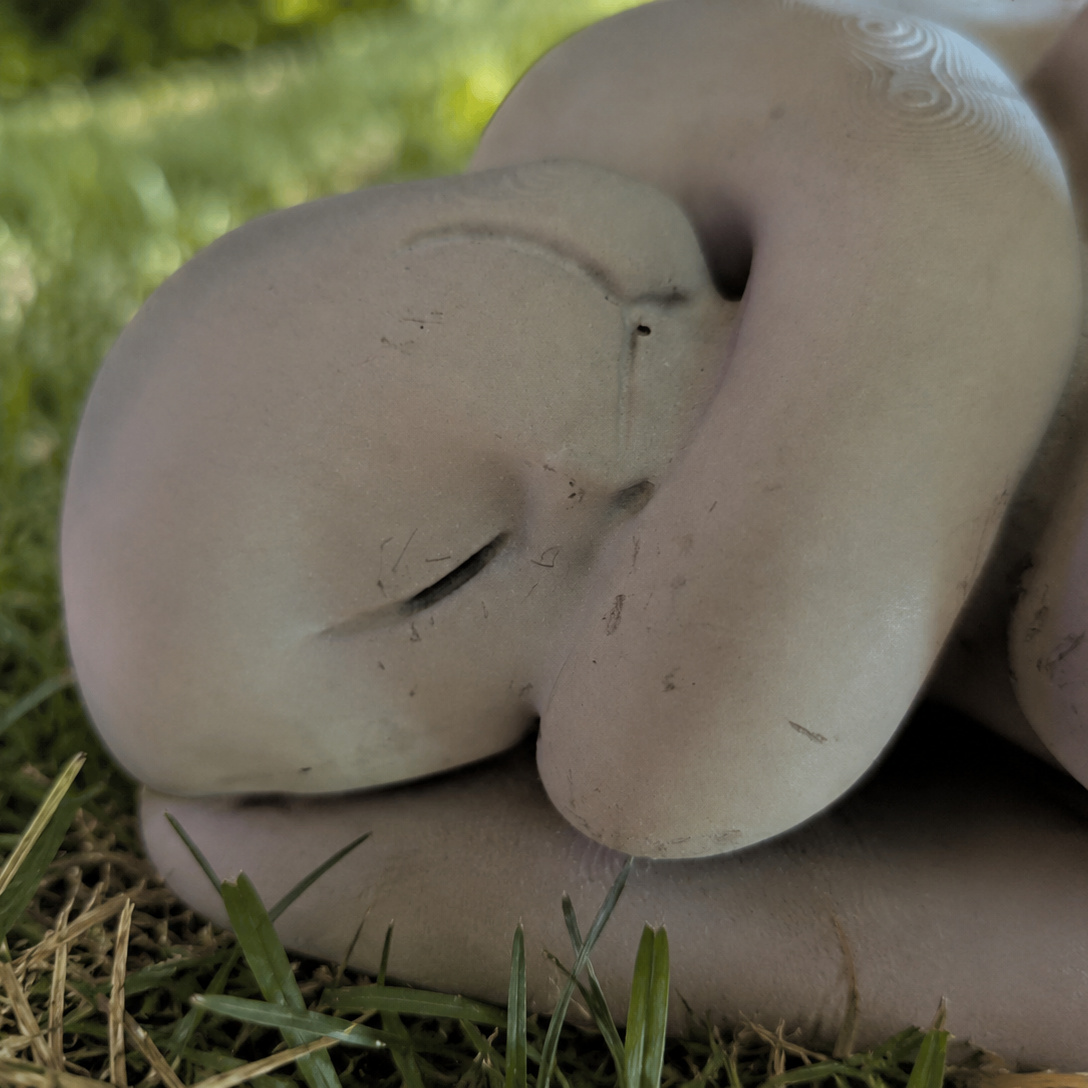 Sleeping Cat Garden Statue close-up of the peaceful sleeping face