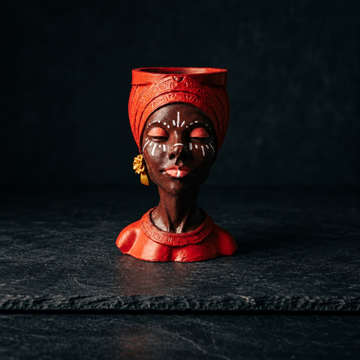 Unplanted red Afro woman head planter shown front-on