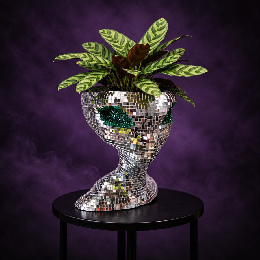 Mirror ball alien planter styled with plants in home setting