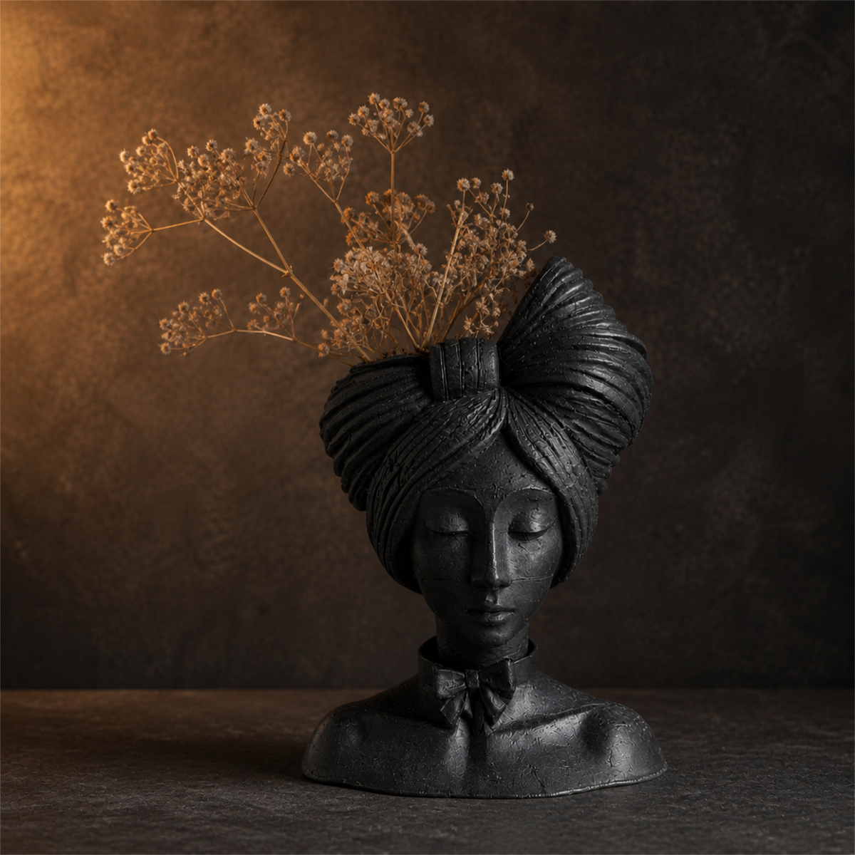 Matte black woman head planter styled with dried stems